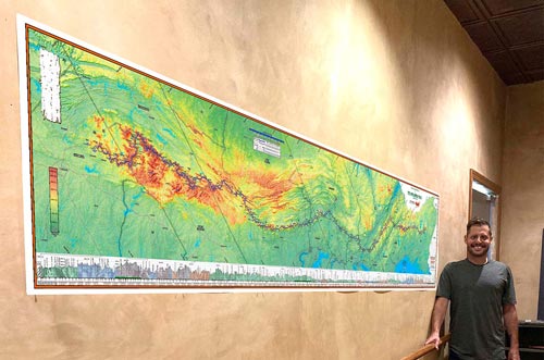 Red Eft Map hung in a hallway next to a man to illustrate scale.